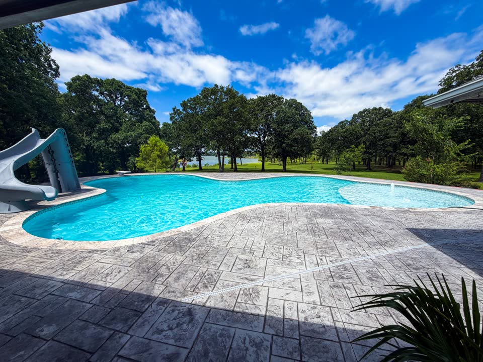 Backyard pool with a slide in Eufala, Oklahoma