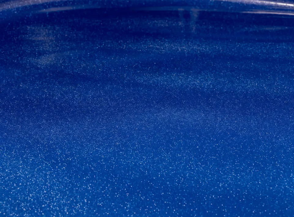 Close up of a fiberglass gelcoat pool shell, shown dry so the texture is visible